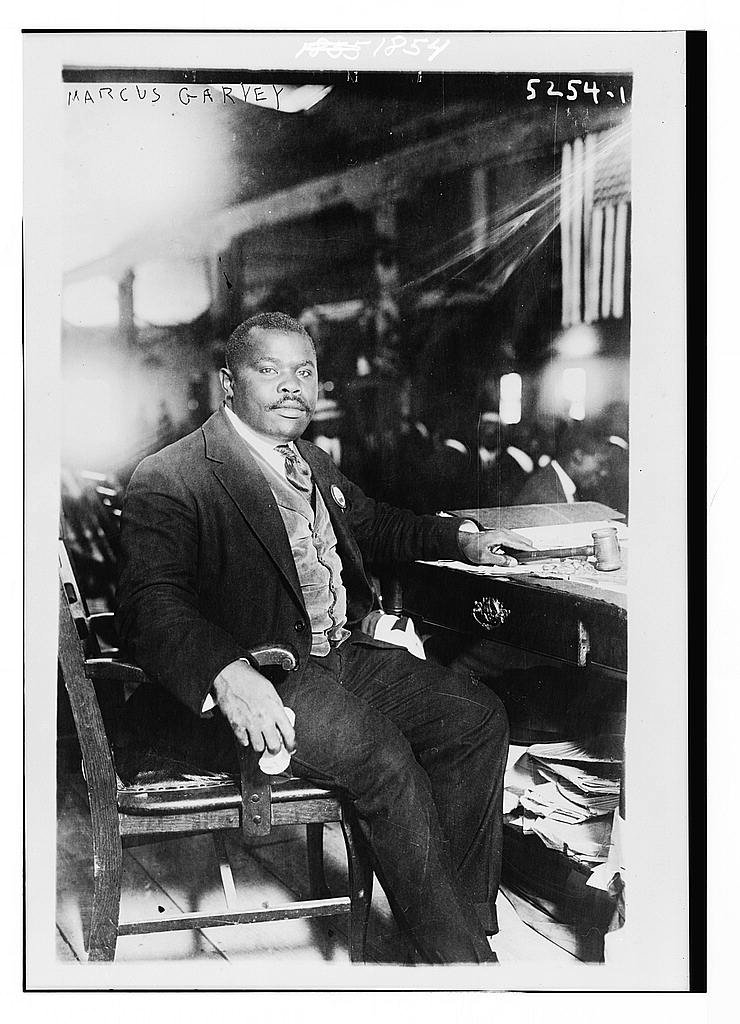 Marcus Garvey seated at a desk in a 1924 photograph.