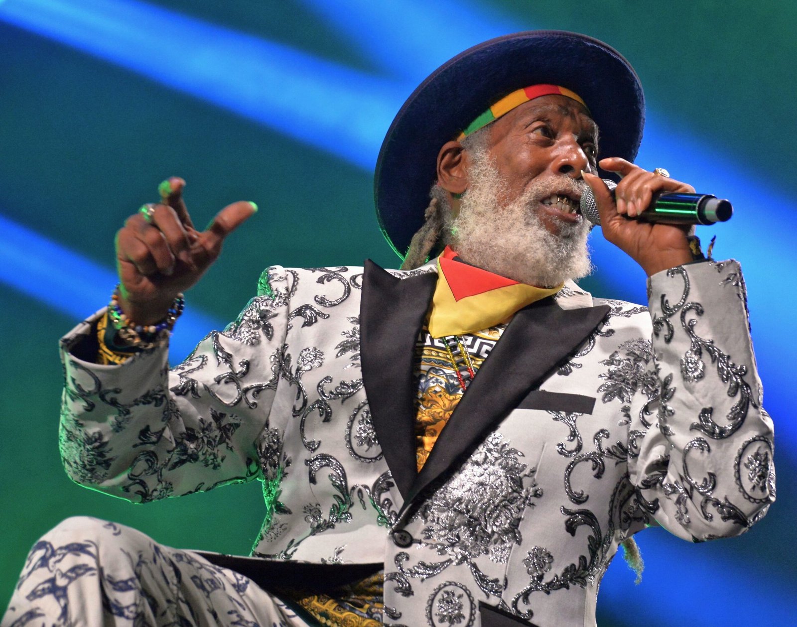 Big Youth performing with a microphone at a reggae concert